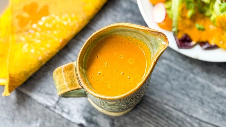 Carrot ginger salad dressing in pitcher