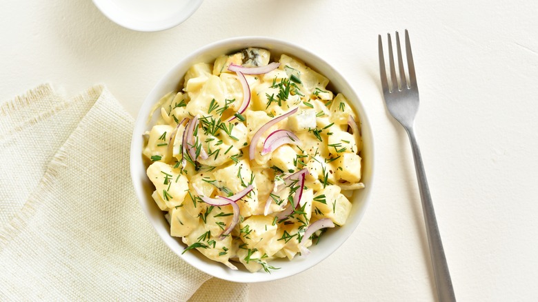 potato salad in bowl with a fork on the side