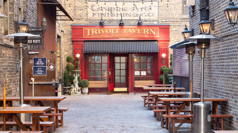 Outside of Chicago's Trivoli Tavern with picnic tables out front.