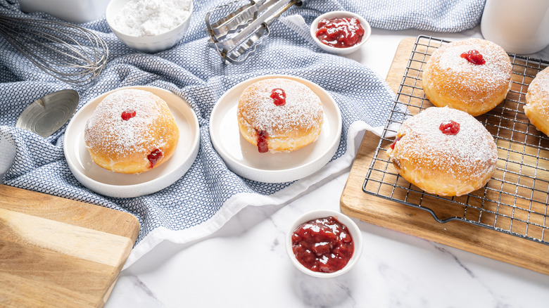 jelly doughnuts on a white marble table