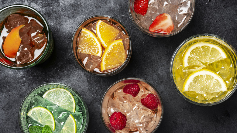 set of summer cocktails garnished with fruit