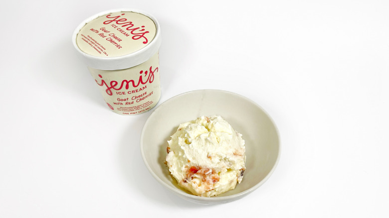 A pint of Jeni's Goat Cheese with Red Cherries next to a bowl of ice cream