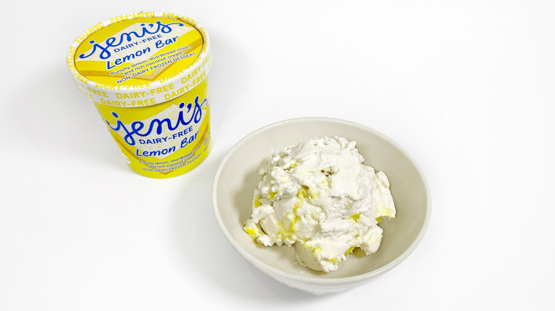 A pint of Jeni's Lemon Bar next to a bowl of ice cream
