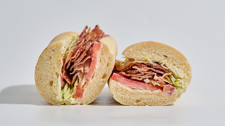 Jimmy John's BLT sandwich sliced in half on a table