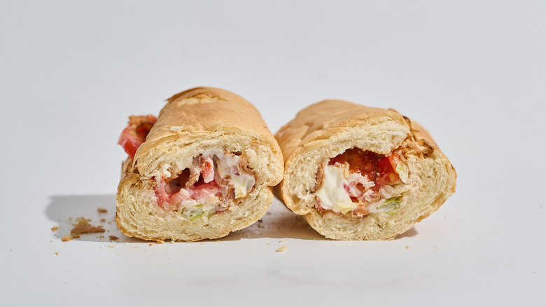 Subway BLT sliced in half on a table