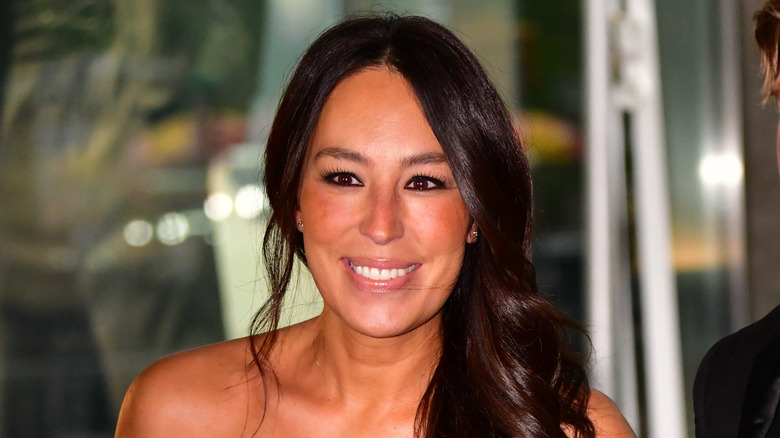 Joanna Gaines smiling with her hair hanging over her shoulder