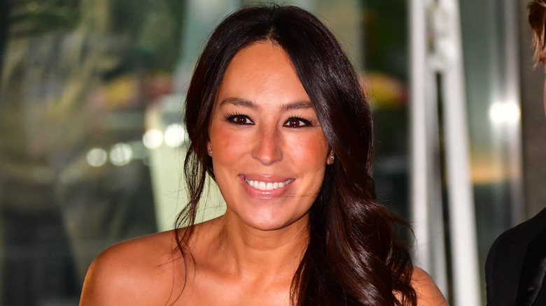 Joanna Gaines smiling with her hair hanging over her shoulder
