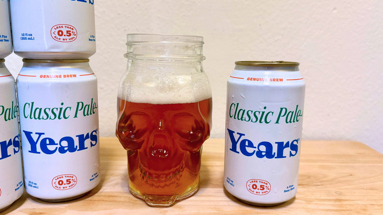 A skull-shaped glass of Years Classic Pale next to its can