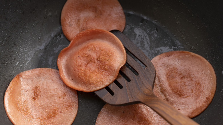 Bologna frying in a pan