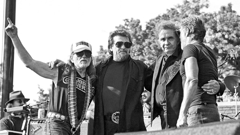 Country supergroup The Highwaymen embrace at the conclusion of a concert.