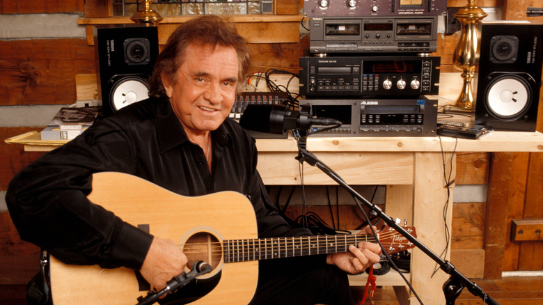 Johnny Cash playing guitar in a studio
