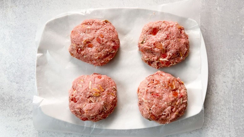 Juicy 3-ingredient tex-mex turkey burger patties on parchment-lined platter ready to be cooked