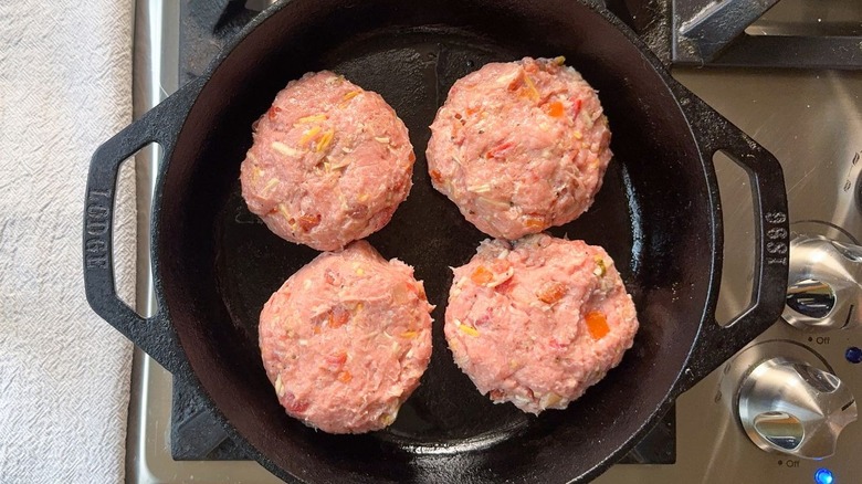 Juicy 3-ingredient tex-mex turkey burgers in cast iron skillet on stovetop
