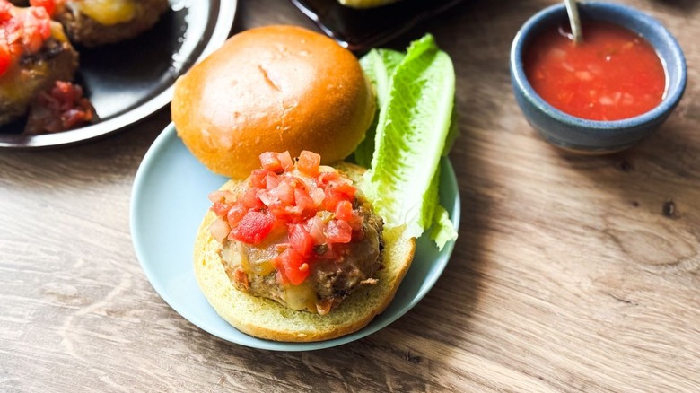 Juicy 3-ingredient tex-mex turkey burger on bun with lettuce and salsa