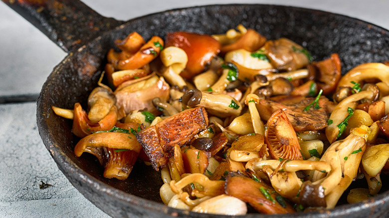 Mushrooms browning in saute pan