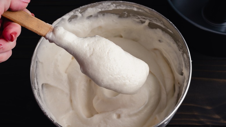 Person holding spatula with batter