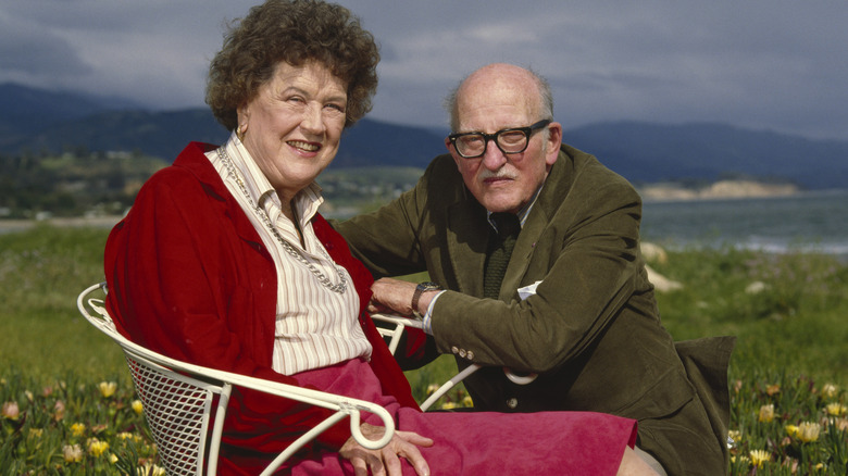 Julia and Paul Child posing for a photo in a field