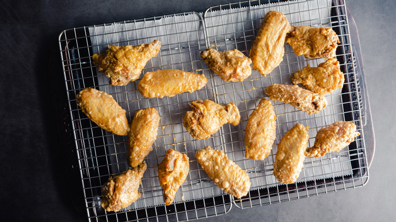 Raw chicken wings on a wire rack