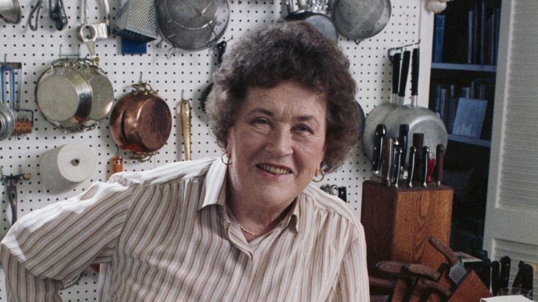 Julia Child smiling in a kitchen