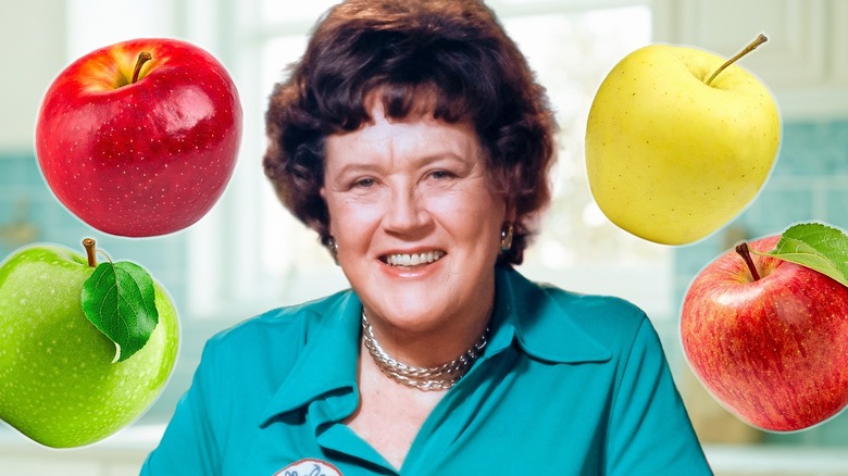 Image of Julia Child surrounded by different apple varieties