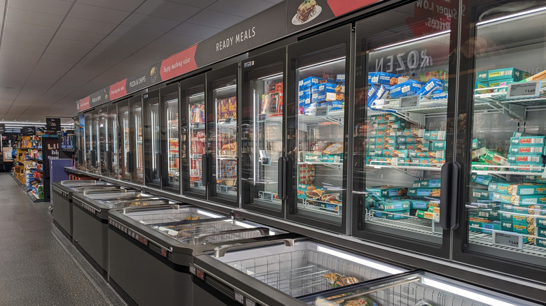 A row of freezers inside an Aldi store containing frozen goods.