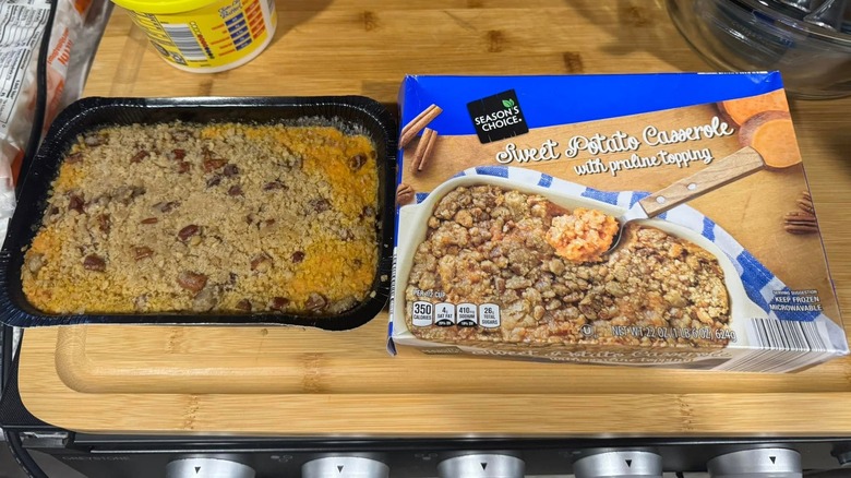 The box of Aldi's Sweet Potato Casserole on the right and its sweet contents in a disposable baking dish on the left