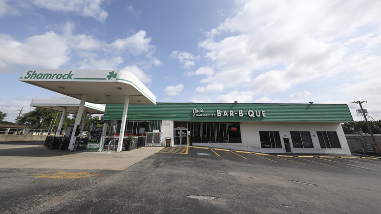 The exterior of Joe's Kansas City Bar-B-Que with Shamrock gas pumps