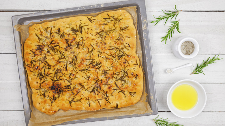 Tray of focaccia bread with herbs