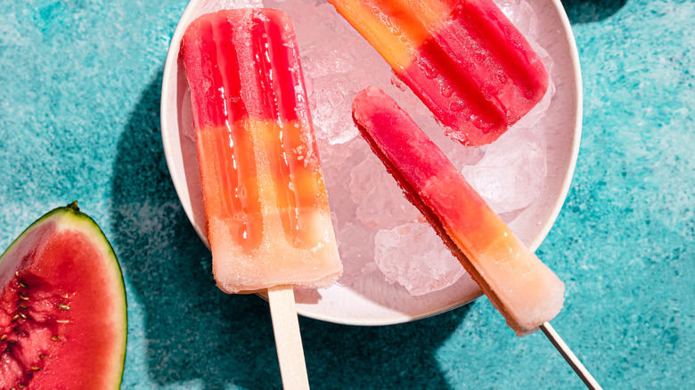 colorful ice popsicles on a pink plate