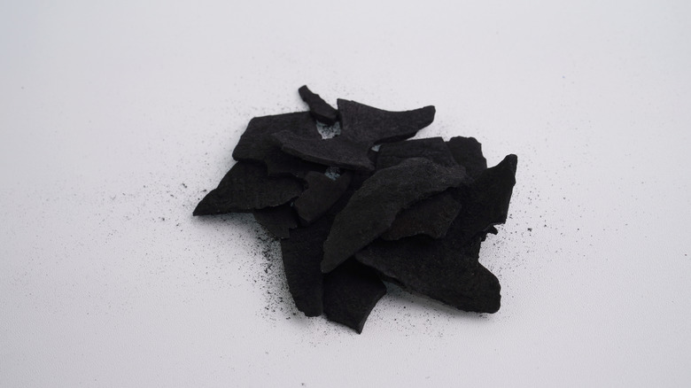 Activated charcoal against an off-white background
