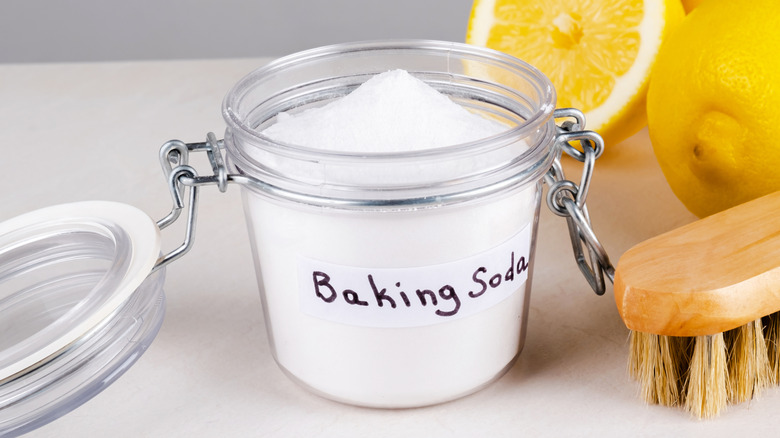 A clear container with powder labeled as baking soda