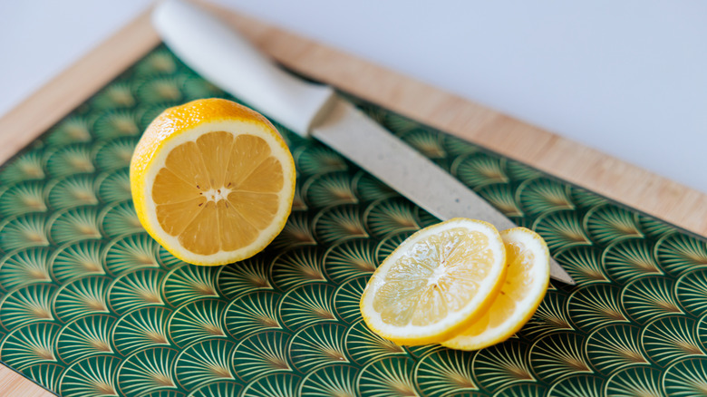 Slices of lemon on a pattered cutting board