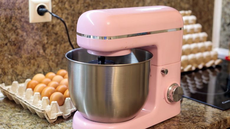 pink stand mixer on a marble counter