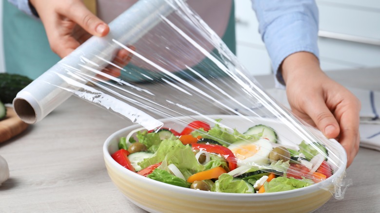 covering salad with cling wrap