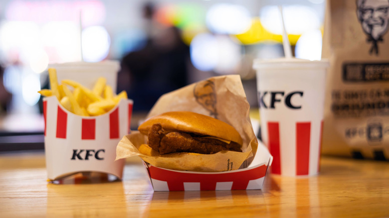 KFC chicken sandwich, fries, and a drink on a table