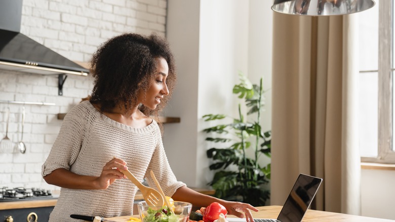 Woman cooking and reading directions