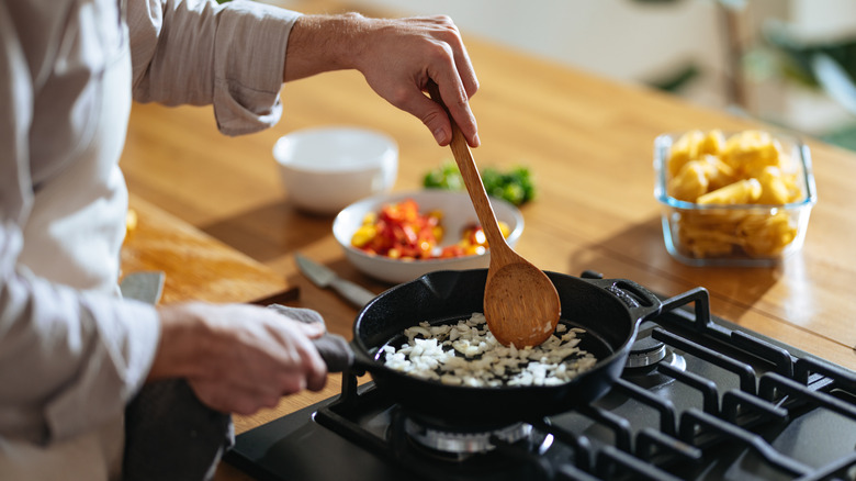 Chef stirring food in frying pan