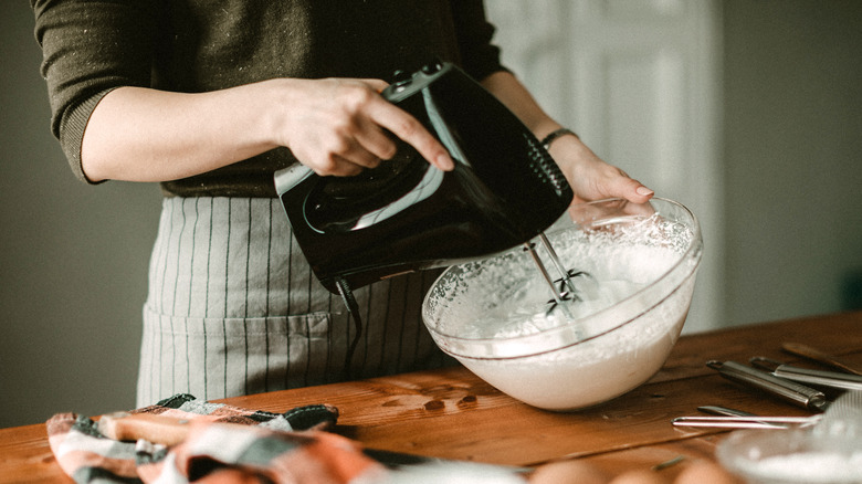Baker using electric mixer