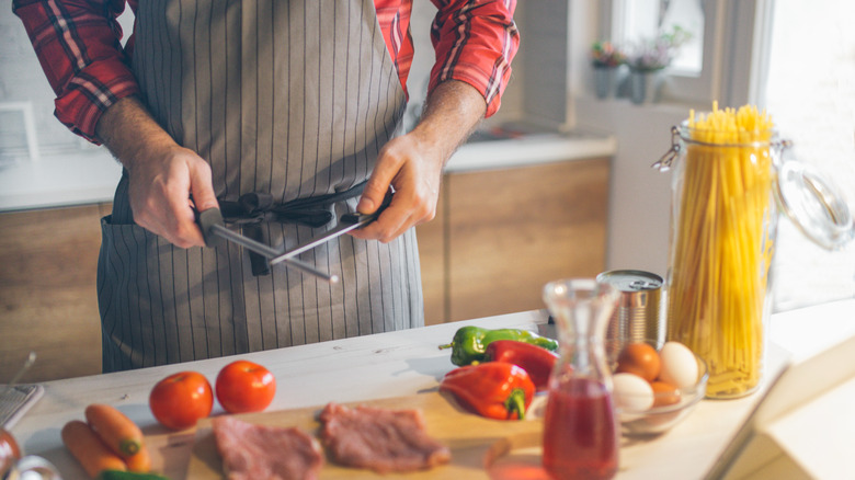 Chef sharpening kitchen knife