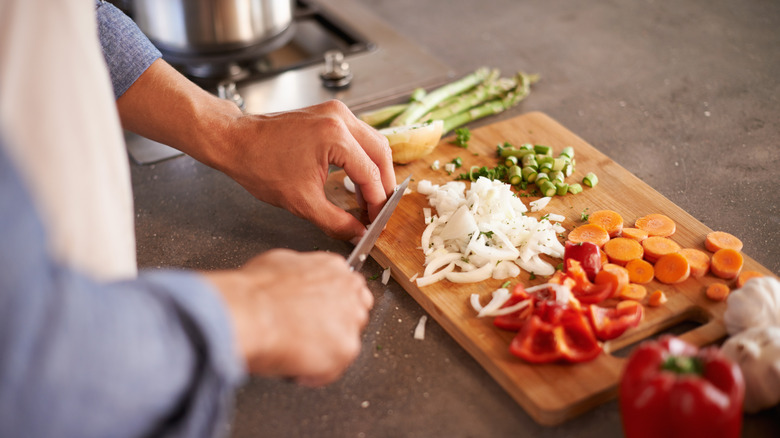 Chopping vegetables on cutting board