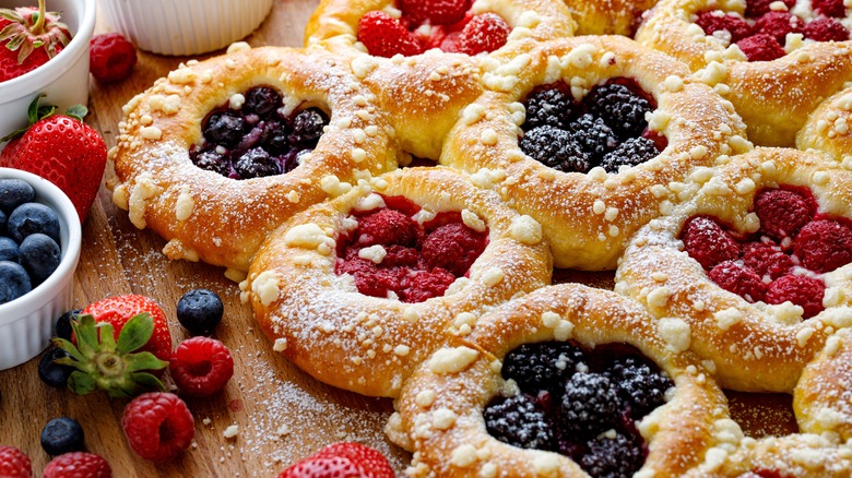 Fruit kolaches sit on a wooden board