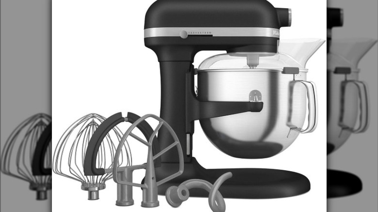 White KitchenAid stand mixer on a kitchen counter next to a tray of cookies