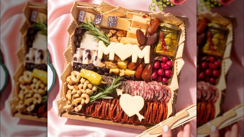 Wooden charcuterie board with salami, pepperoni, cheeses, olives, dates, and nuts