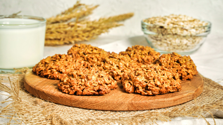 a plate of cookies next to glass of milk