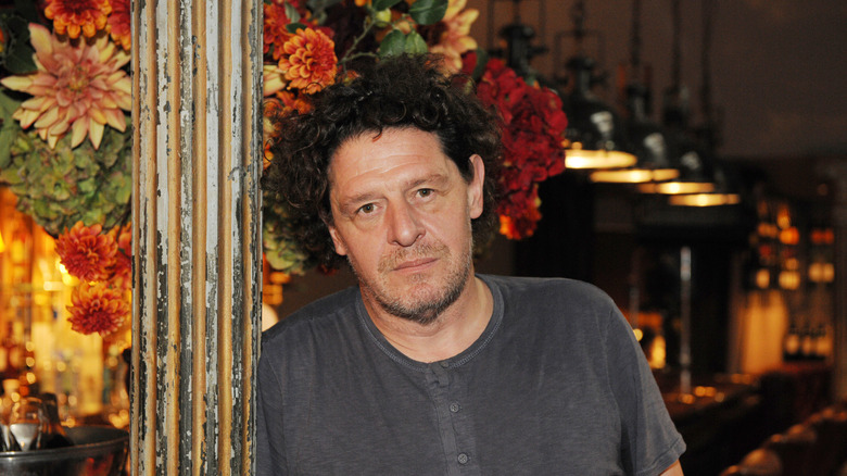 Marco Pierre White in grey shirt looking into the camera