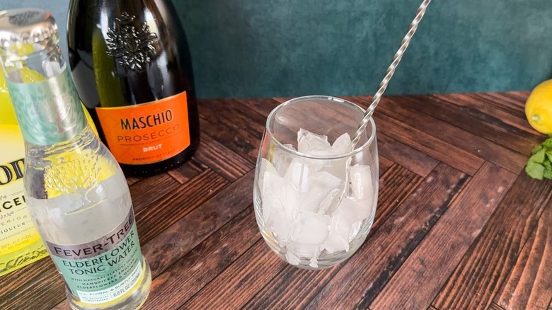 Stirring ice in a balloon glass with a bar spoon