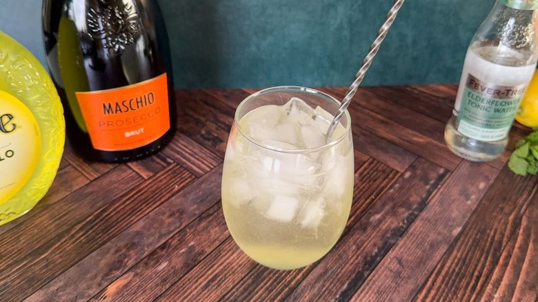 Stirring a limoncello Amalfi spritz with a bar spoon in a balloon glass