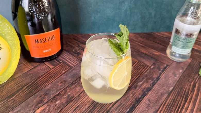 Limoncello Amalfi spritz in balloon glass on counter with liquor bottles