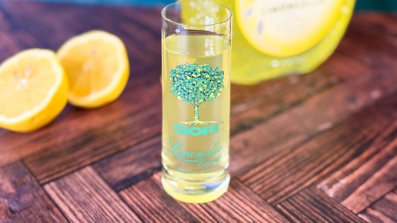 Small limoncello glass and lemons