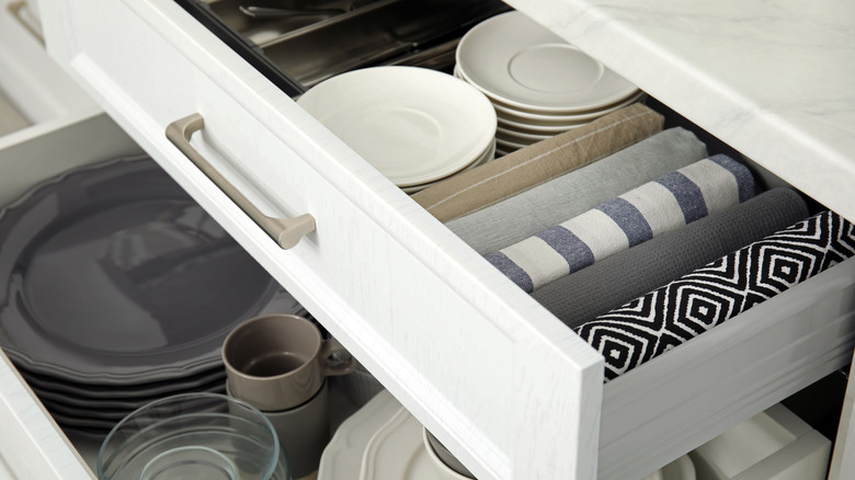 Kitchen drawer with kitchenware and towels